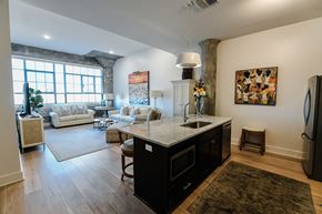 New Orleans apartment for rent - A kitchen with a black fridge and a white counter top.