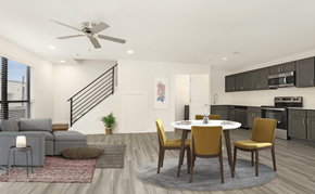 Houma townhouse for rent - A modern living room with a grey sofa, a grey armchair, a grey side table, a grey rug, a white table, a white ceiling fan, a white door, a white wall, a black staircase, a