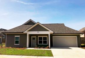 Tupelo apartment for rent - a house with a garage door and a lawn