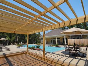 Covington apartment for rent - a backyard with a pool and a wooden pergola