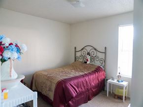 Monroe apartment for rent - a bedroom with a bed and a vase of flowers