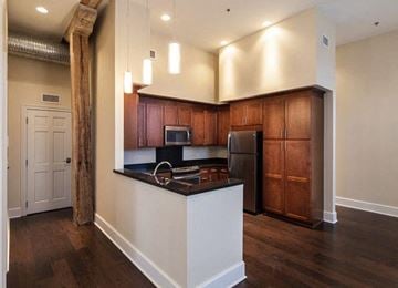 New Orleans apartment for rent - A kitchen with wooden cabinets and a white island.