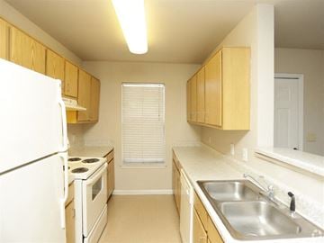 Scotlandville apartment for rent - a kitchen with a stove refrigerator and sink