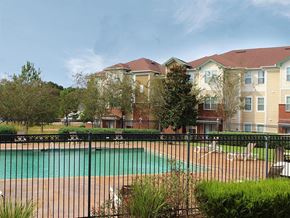 Mccomb apartment for rent - a swimming pool with apartments in the background