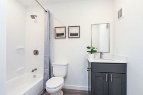 Baton Rouge townhouse for rent - A white toilet sits next to a white sink in a bathroom.