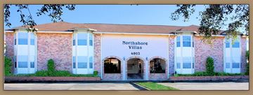 Slidell apartment for rent - A building with the sign Northshore Villas 4802 on it.
