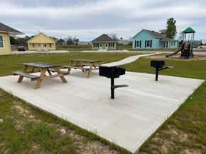 Bastrop apartment for rent - a large patio with picnic tables and a grill on it