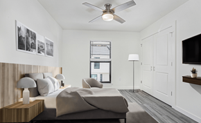 Gonzales apartment for rent - A bedroom with a large bed and a ceiling fan.