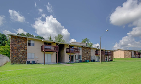 Jackson apartment for rent - A row of houses with a grassy field in front.