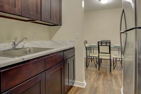 Jackson apartment for rent - A kitchen with a white sink and brown cabinets.