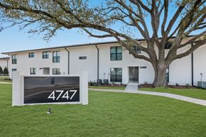 Baton Rouge apartment for rent - A sign with the number 4747 is in front of a building with a tree.