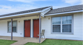 Shreveport apartment for rent - A house with a red door and a grey chair.