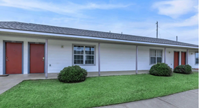 Shreveport apartment for rent - A white house with red doors and windows.