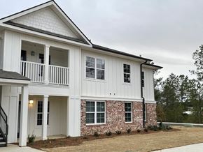Tupelo apartment for rent - a white and brick house with a porch and a balcony