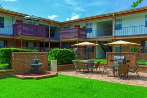 Harahan apartment for rent - A sunny day at the apartment complex with a fountain in the courtyard.