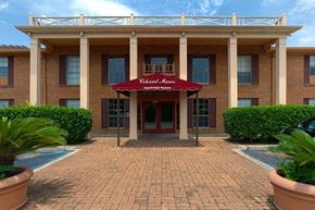 Harahan apartment for rent - A building with a red awning that says "Valencia Apartments" in front of it.