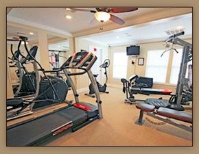 Slidell apartment for rent - A gym with treadmills, elliptical machines and weights.