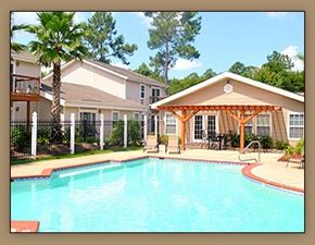 Slidell apartment for rent - A pool in front of a house with a patio.