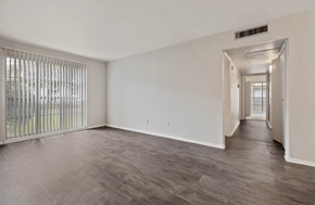 Shreveport apartment for rent - A room with a sliding door and a window with blinds.