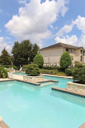 Baton Rouge apartment for rent - a large swimming pool with a house in the background