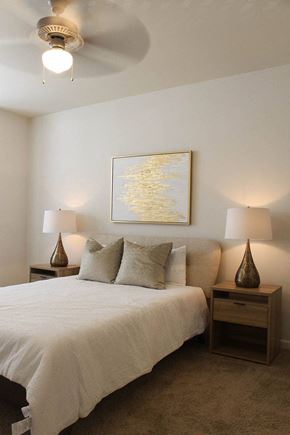 Baton Rouge apartment for rent - a bedroom with a white bed and a ceiling fan