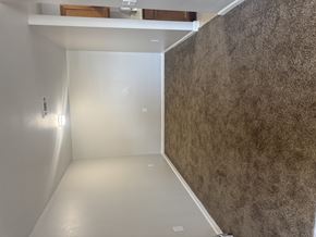 Sulphur apartment for rent - A room with a white wall and a brown wall.