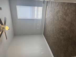 Sulphur apartment for rent - A room with a ceiling fan and a window.