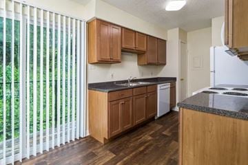 Lafayette apartment for rent - A kitchen with wooden cabinets and a white refrigerator.