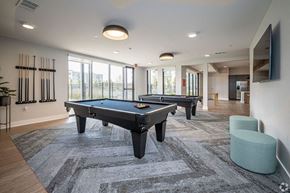 Baton Rouge apartment for rent - a game room with two pool tables and a tv