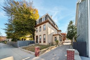 Philadelphia apartment for rent - a house on the corner of a street with a sidewalk