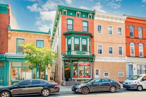 Philadelphia apartment for rent - a city street with cars parked in front of a building