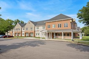 Philadelphia apartment for rent - A large building with a parking lot in front at Roosevelt Commons Apartments, Philadelphia, PA