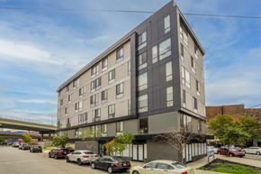 Philadelphia apartment for rent - an apartment building on a city street with cars parked