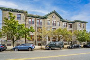 Philadelphia apartment for rent - a large brick building with cars parked in front of it