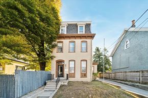 Philadelphia apartment for rent - the front of a house with a yard and a fence