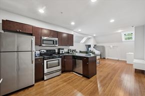 Philadelphia apartment for rent - A kitchen with wooden floors and stainless steel appliances.