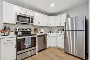 Philadelphia apartment for rent - A kitchen with white cabinets and stainless steel appliances at Roosevelt Commons Apartments, Philadelphia, 19152