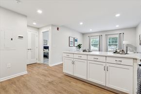 Philadelphia apartment for rent - A white kitchen with wood floors and white cabinets at Roosevelt Commons Apartments, Pennsylvania 19152
