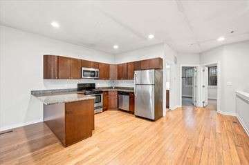 Philadelphia apartment for rent - A kitchen with wooden cabinets and stainless steel appliances.