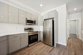 Philadelphia apartment for rent - a kitchen with stainless steel appliances and white cabinets