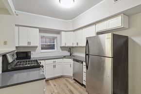 Philadelphia apartment for rent - a kitchen with white cabinets and stainless steel appliances