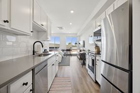 Philadelphia apartment for rent - a large kitchen with stainless steel appliances and white cabinets at The Commons On Ludlow Apartments, Philadelphia