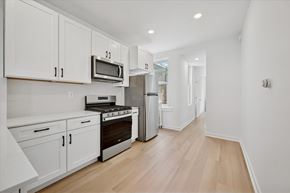 Philadelphia apartment for rent - A kitchen with white cabinets and appliances.