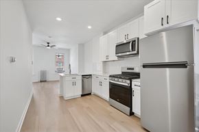 Philadelphia apartment for rent - A modern kitchen with stainless steel appliances and white cabinets.