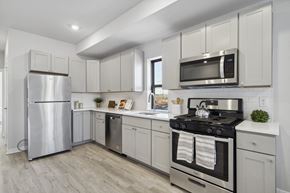 Philadelphia apartment for rent - a white kitchen with stainless steel appliances and white cabinets