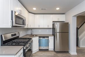 Conshohocken apartment for rent - a kitchen with white cabinets and stainless steel appliances