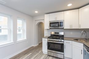 Conshohocken apartment for rent - a kitchen with white cabinets and stainless steel appliances