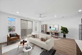 Philadelphia apartment for rent - A modern living room with a white couch, a brown chair, and a coffee table.