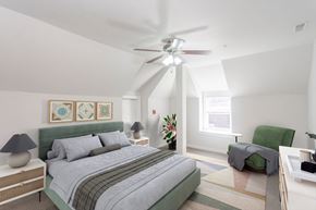 Philadelphia apartment for rent - A bedroom with a bed, a chair, and a ceiling fan.
