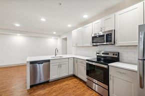 Philadelphia apartment for rent - a kitchen with white cabinets and stainless steel appliances